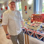 Care home chef presenting Coronation cake